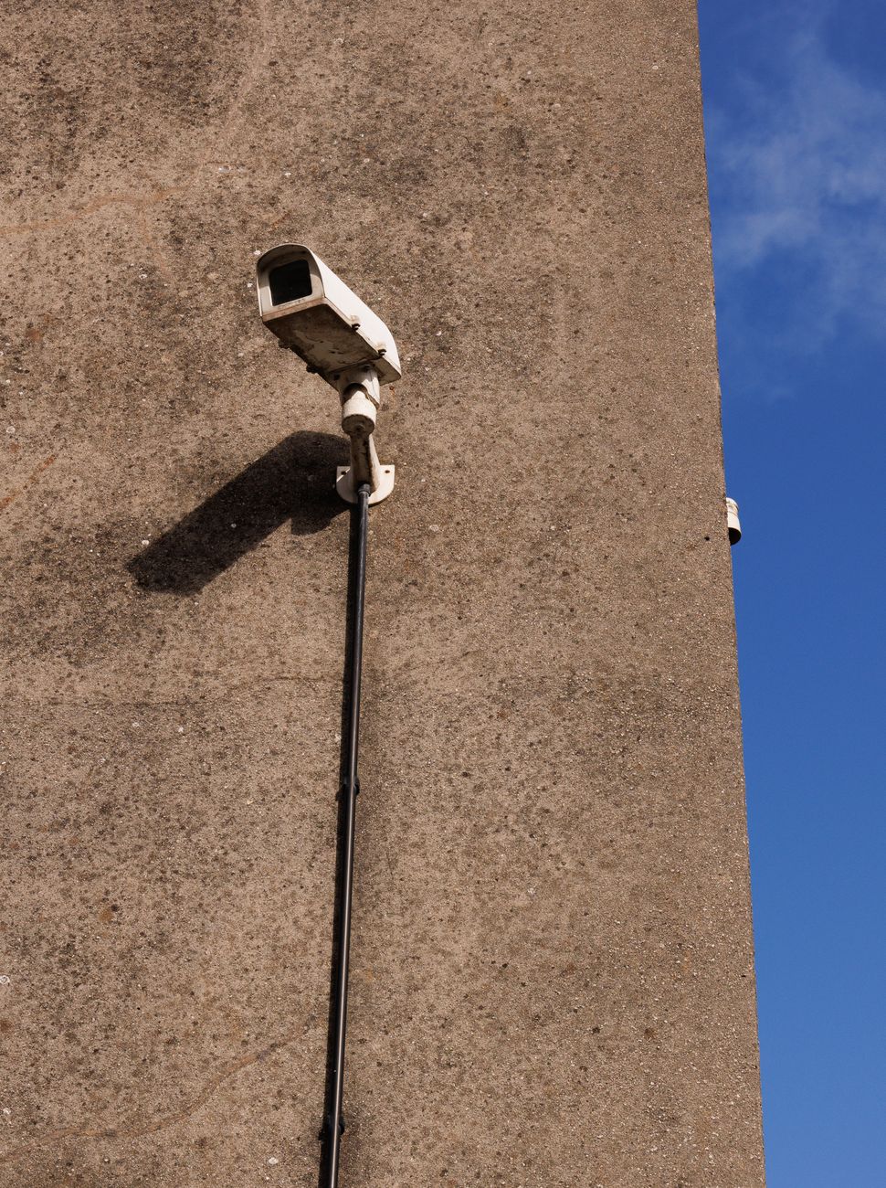 Security camera mounted on a building wall