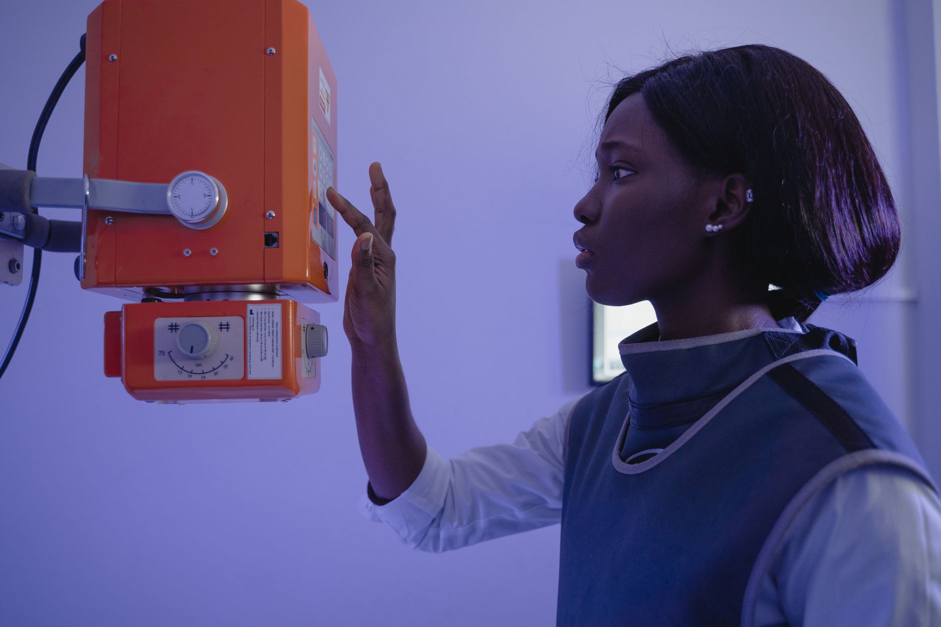 Radiographer positioning an X-ray machine
